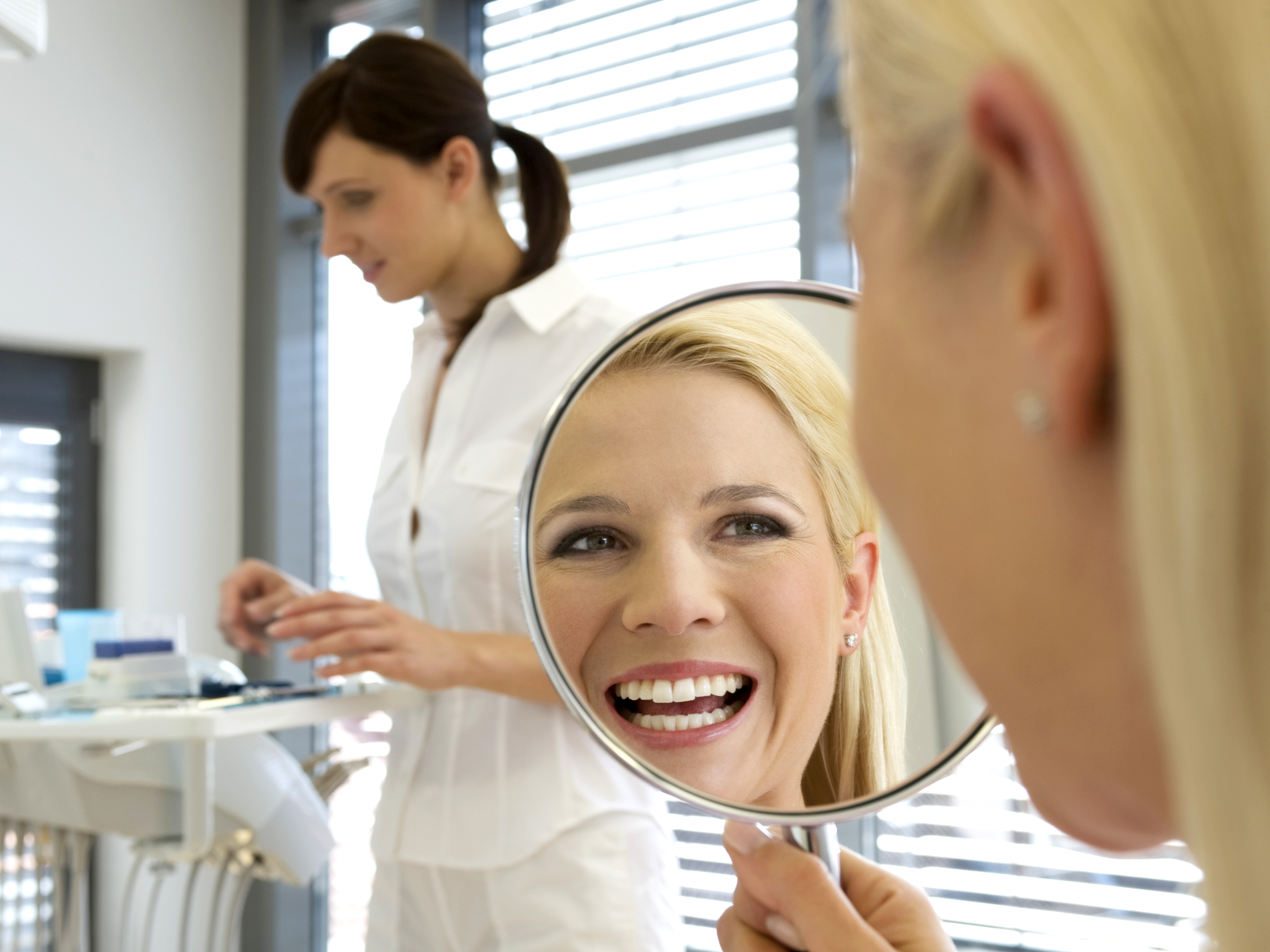 Dental-patient-smiling-in-mirror-1